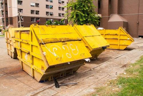 Construction site with builders managing waste clearance in Sutton
