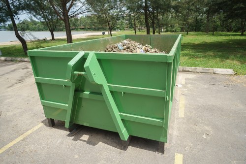 Workers loading rubbish into a transit van in Sutton